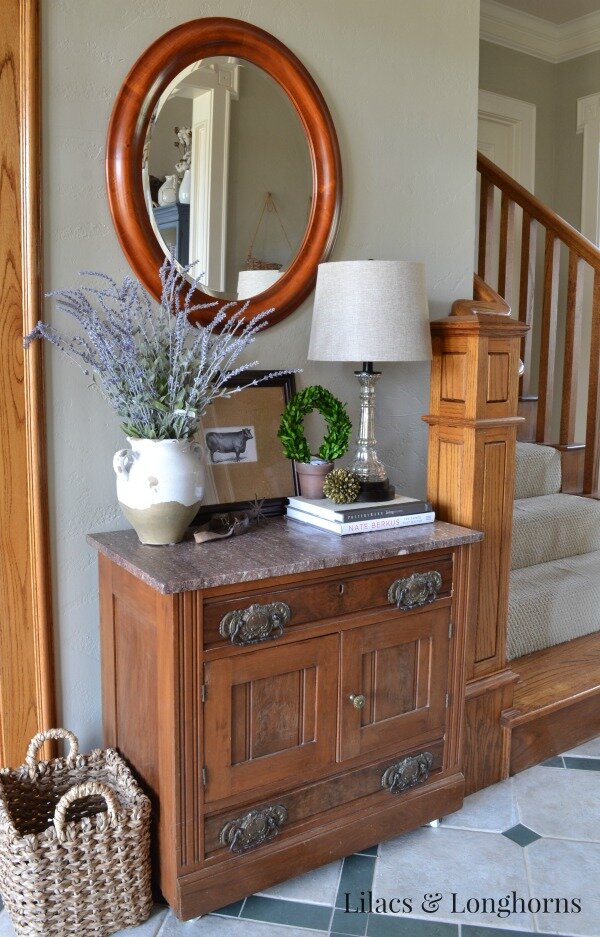 An antique marble top chest fits perfectly on this small wall.