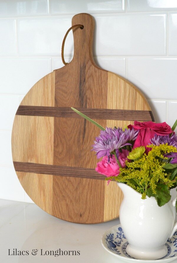 A beautiful hand-made cutting board adds a rustic touch to the kitchen.