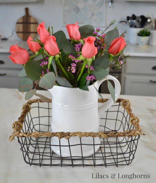 roses in a white pitcher