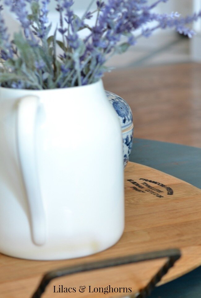 white pitcher on wine barrel cheese tray